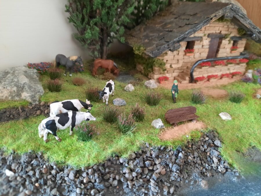 Mountain diorama with real rocks and epoxy resin, dedicated to Celtica Festival: detail of the cows
