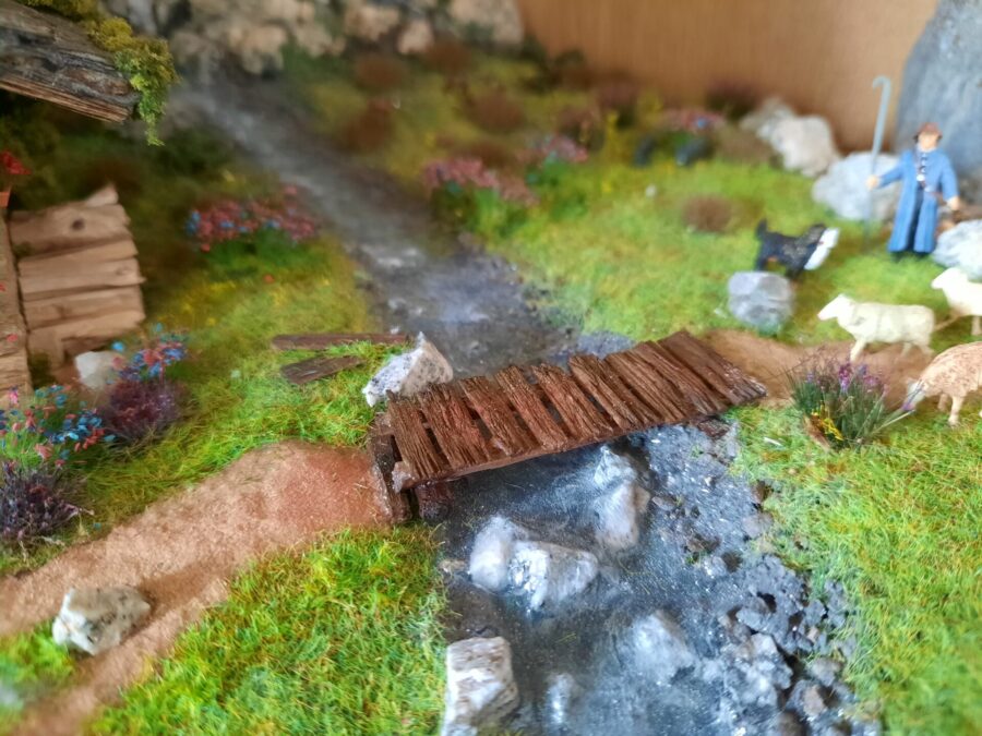 Mountain diorama with real rocks and epoxy resin, dedicated to Celtica Festival: detail of the bridge over the stream