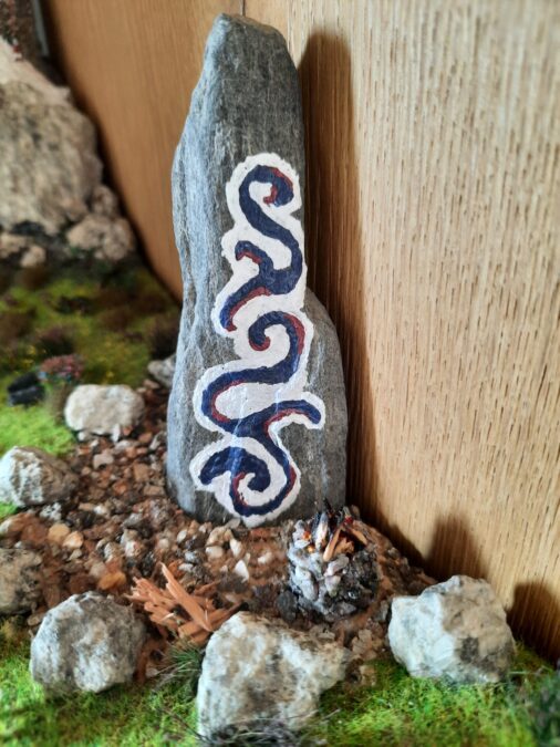 Mountain diorama with real rocks and epoxy resin, dedicated to Celtica Festival: detail of the Menhir with bonfire