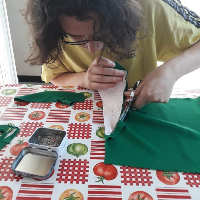 Making my Irish dance Solo dress: cutting triangles in green fabric to add to the skirt