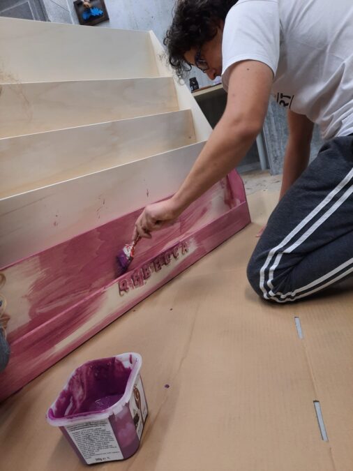 Locutus painting the Montessori bookshelf pink
