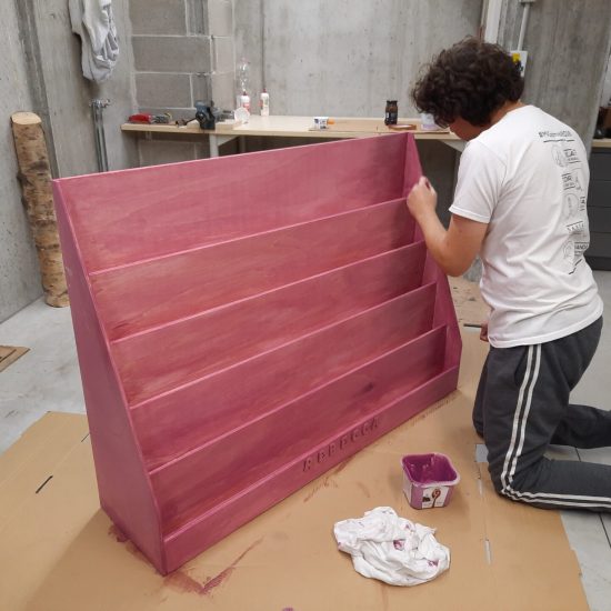Locutus painting the Montessori bookshelf pink