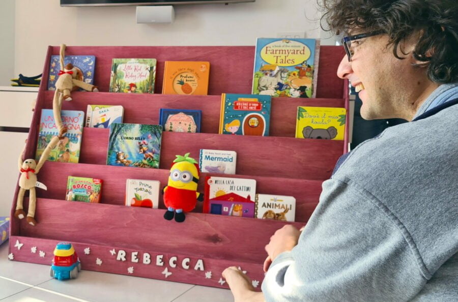 Locutus proudly showing the finished Montessori bookshelf to our daughter the day of her first birthday