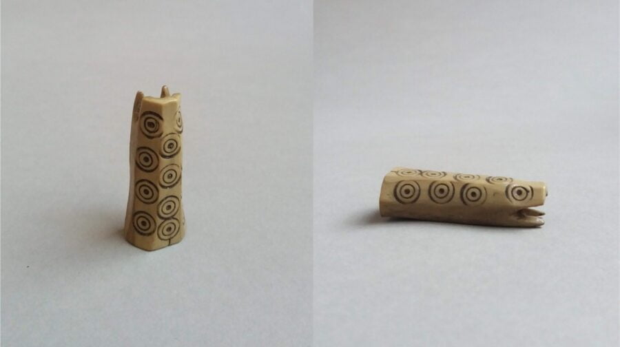 A small hollowed-out bone object decorated with point circles from Norway, possibly a lucet from the Middle ages