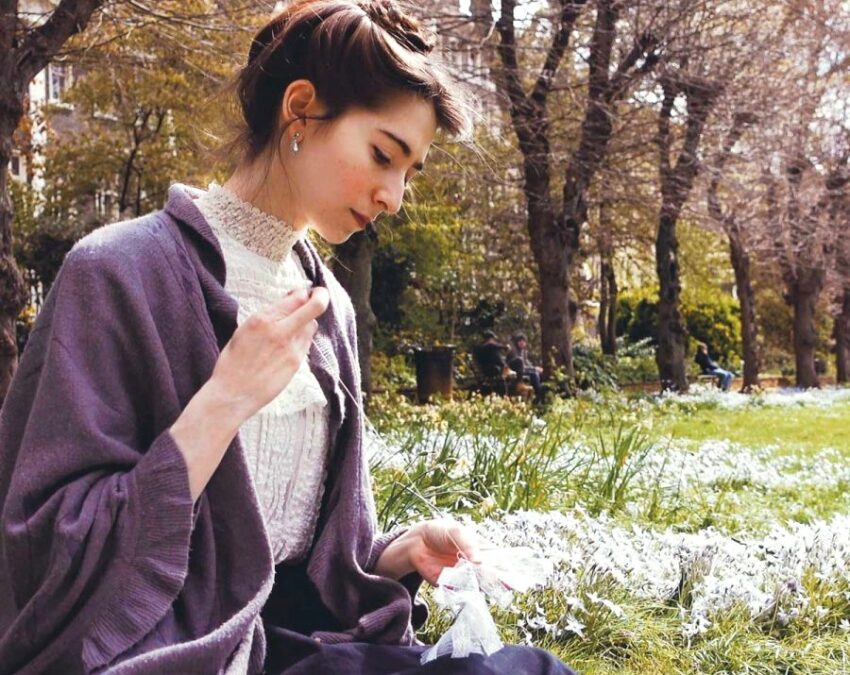 Bernadette Banner hand sewing in the open air