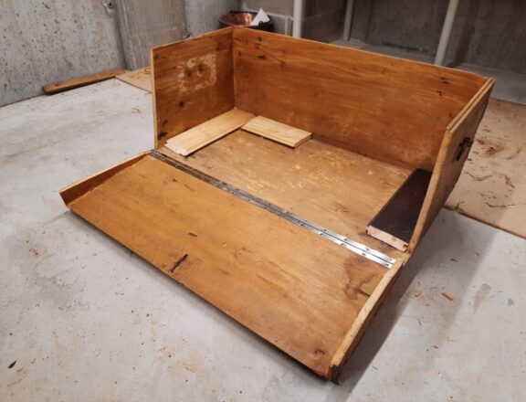 The steamer trunk open, with hinges installed