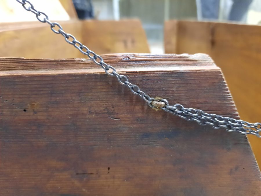 Steamer trunk with chains installed, detail