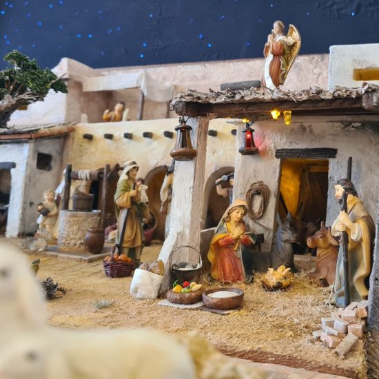 Nativity diorama inside an antique steamer trunk: the holy family