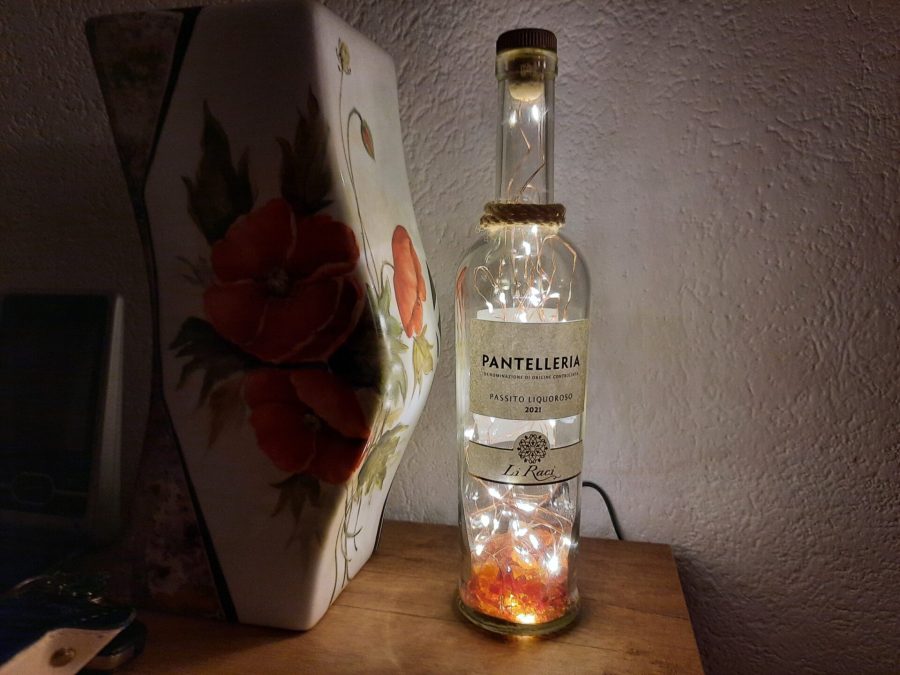 Bottle lamp with colored glass scraps inside
