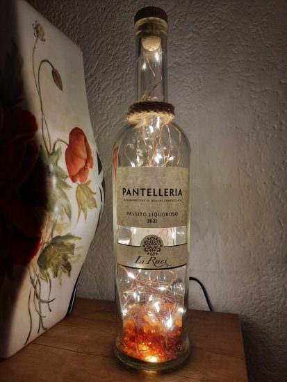 Bottle lamp with colored glass scraps inside