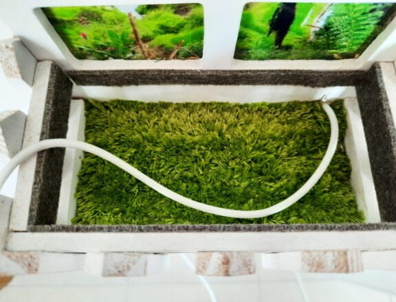 Inside the flower pot of the USB charging station there's a grass all hand-embroidered using turkey stitch or fringe stitch