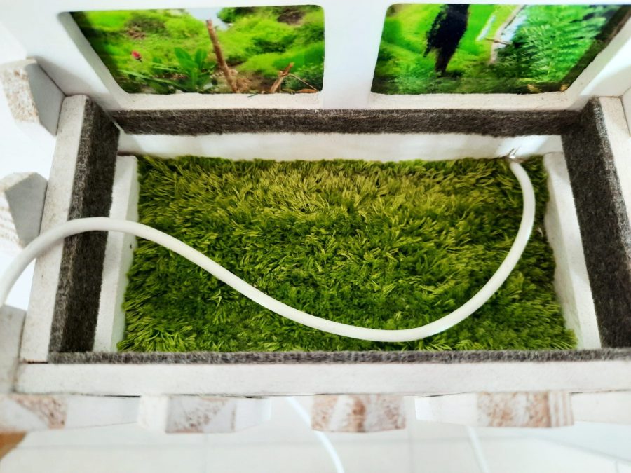 Inside the flower pot of the USB charging station there's a grass all hand-embroidered using turkey stitch or fringe stitch