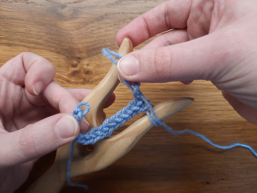 Making a loop with the lucet, step 3: get the thread on your left prong inside the small loop