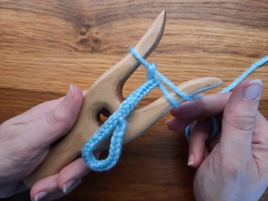 Making a loop with the lucet, step 4: finish your braid, while hiding the tail inside the new stitches