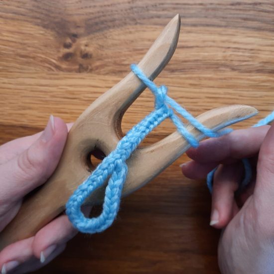 Making a loop with the lucet, step 4: finish your braid, while hiding the tail inside the new stitches