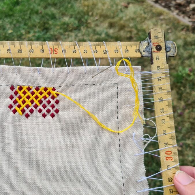 Detail of how I dressed my project on the folding ruler embroidery frame