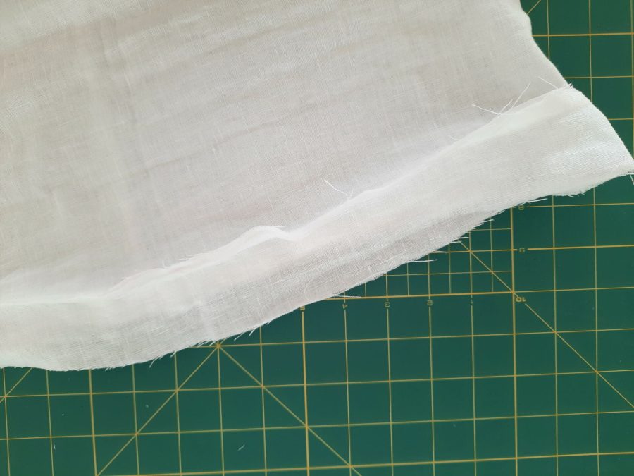 Turning a thrifted linen caftan into a shirt: making the bottom hem