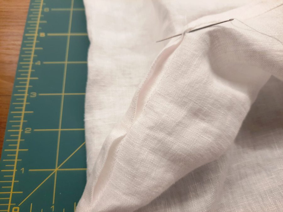 Turning a thrifted linen caftan into a shirt: hand-sewing the bottom hem with invisible hand-stitches
