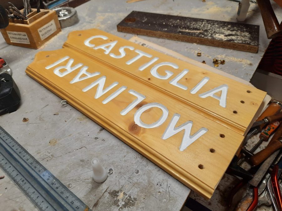 Splitting the wooden sign into two halves: drilling the holes for the cord