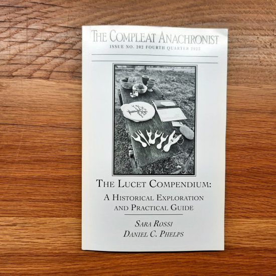 Printed copy of "The Lucet Compendium: a historical exploration and practical guide", book by Sara Rossi and Daniel Craig Phelps about the history of the lucet with practical guidance for modern crafters.