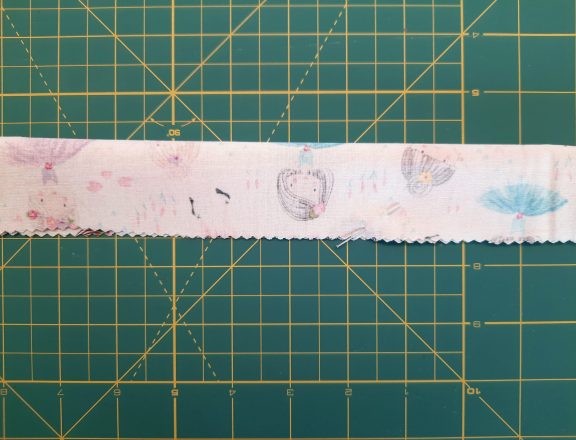 Sewing a scrunchie: make a tube of fabric, short sides open. Also leave an opening in the middle of the bottom long side (it will be used later for turning upright)