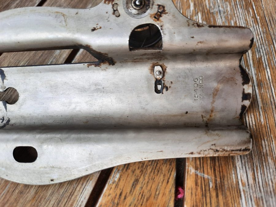 The inside of the metal plaque closing the tension unit of our Singer sewing machine: we removed it to clean it