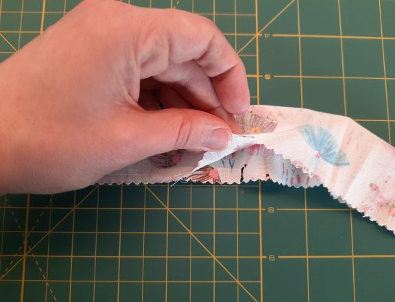 Sewing a scrunchie: make a tube of fabric, short sides open. Also leave an opening in the middle of the bottom long side (it will be used later for turning upright)