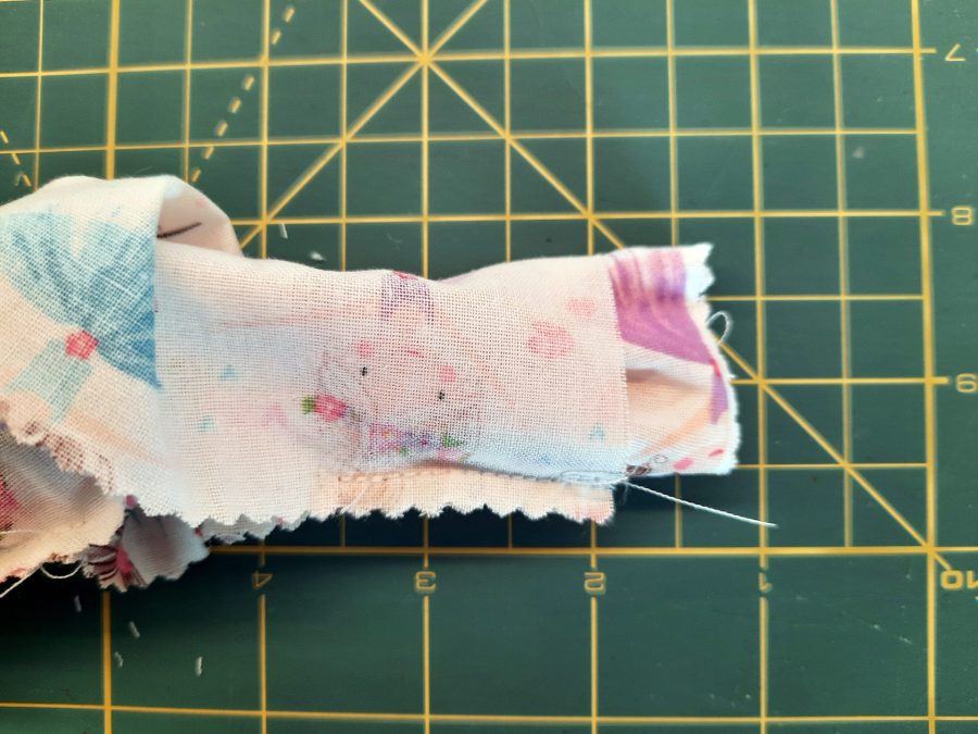 Sewing a scrunchie: turn the tube of fabric halfway right so the short sides match