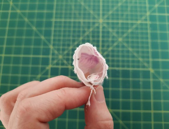 Sewing a scrunchie: turn the tube of fabric halfway right so the short sides match. Match the seams and pin your short sides and pin in place.