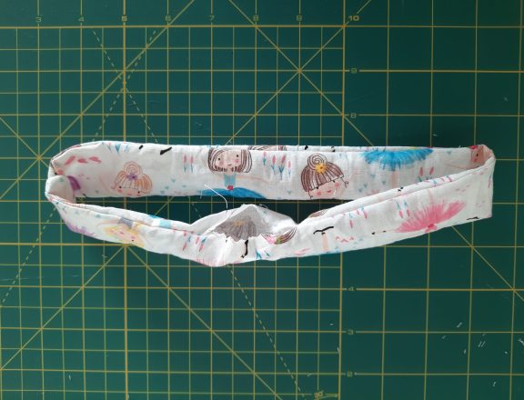 Sewing a scrunchie: turn the fabric tube upright using the opening at the bottom