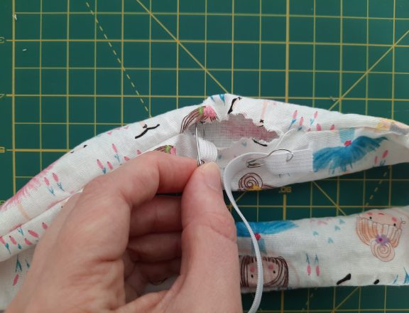 Sewing a scrunchie: use a safety pin to thread elastic throug the ring of fabric