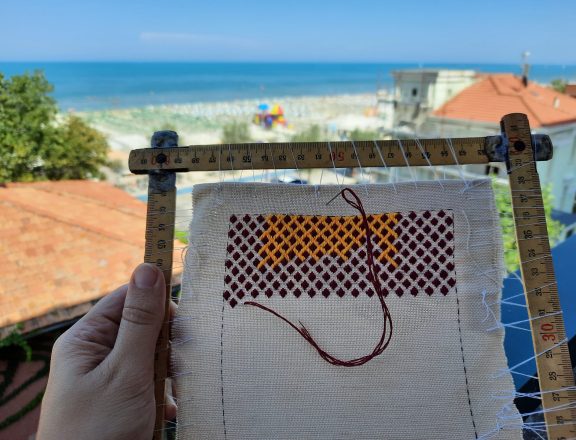 Brick stitch embroidered needle roll: working on vacation