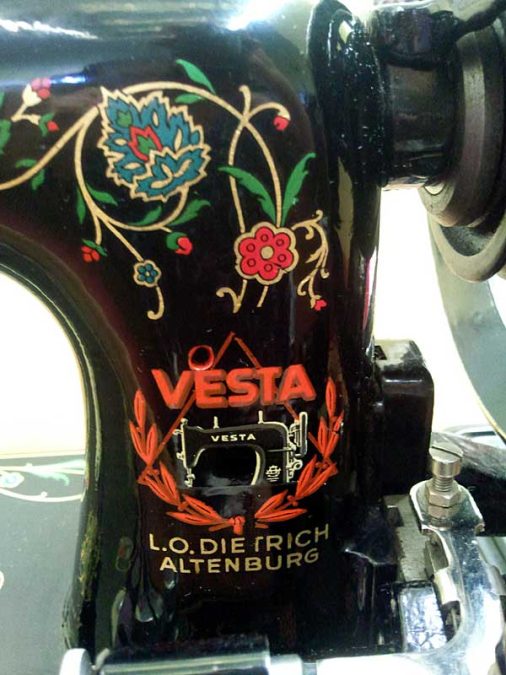 Vesta sewing machine triangle and circle badge, 1930s. The basic triangle and circle logo with wreath underneath was introduced in 1932. "Vesta" was added in 1933 and L.O. Dietrich-Altenburg curved around the logo in 1934. It is unsure whether this version, with L.O. Dietrich Altenberg blocked underneath, dated slightly later, but it was before 1937.