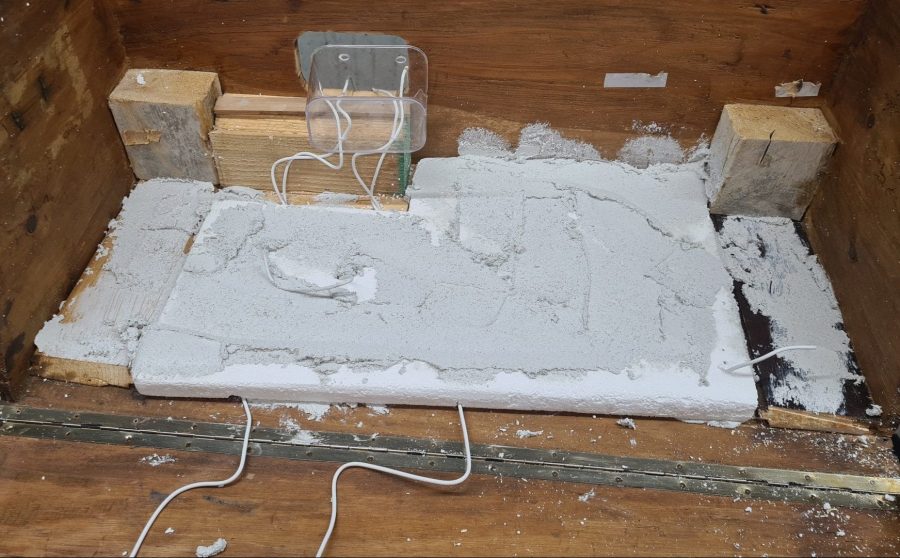 Making the landscape for our Christmas nativity diorama inside the steamer trunk: the cement coating