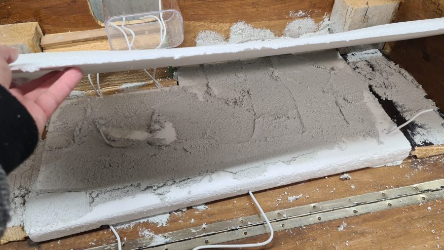 Making the landscape for our Christmas nativity diorama inside the steamer trunk: the cement coating