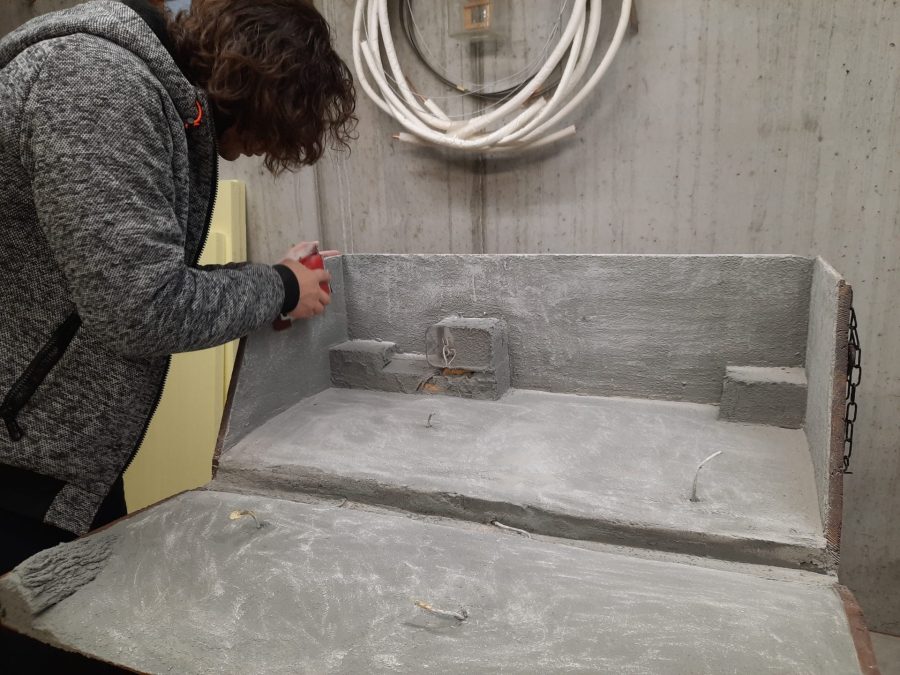 Making the landscape for our Christmas nativity diorama inside the steamer trunk: the cement coating