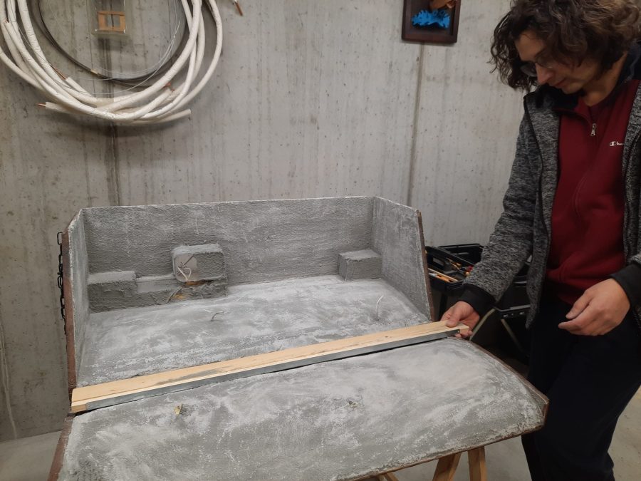 Making the landscape for our Christmas nativity diorama inside the steamer trunk: the cement coating