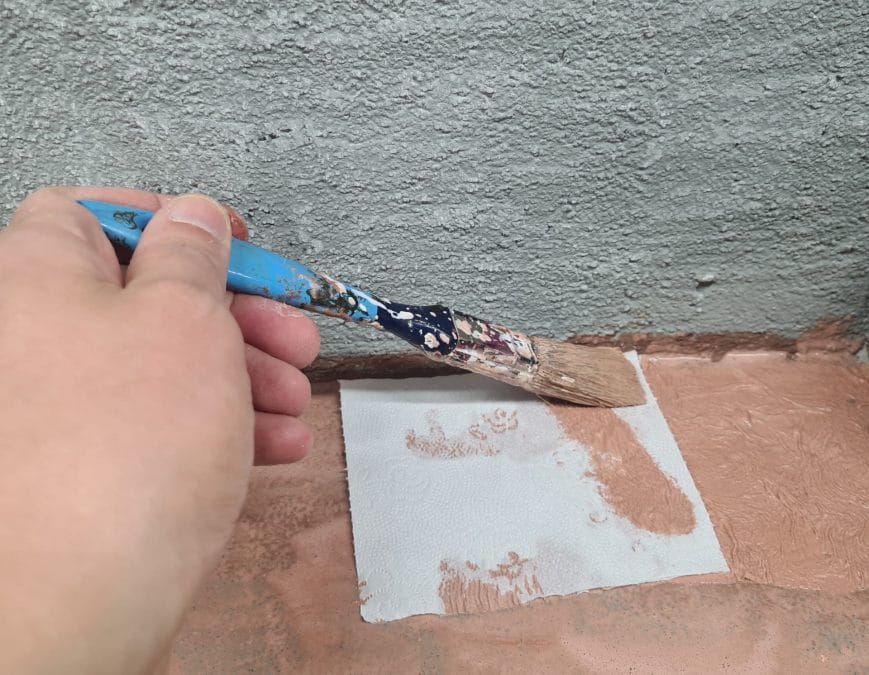 Painting the terrain for our Christmas nativity diorama inside the steamer trunk