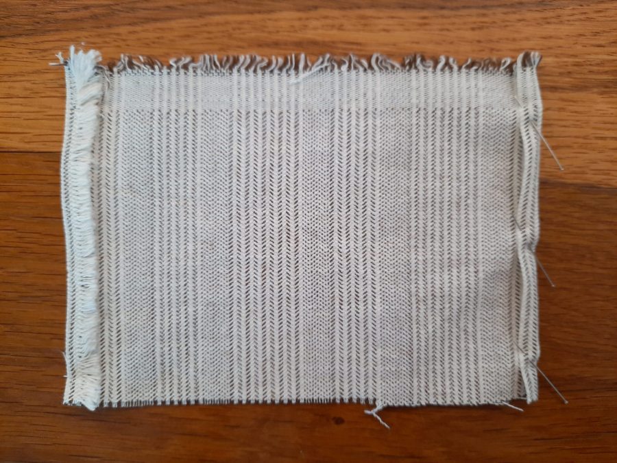 Preparing the pocket for my embroidery project travel bag: pin the hems