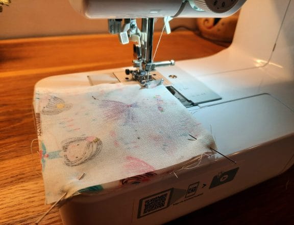 Sewing a corner bookmark: sew all the way around the edge of your fabric sandwich, leaving a turning gap along one side.