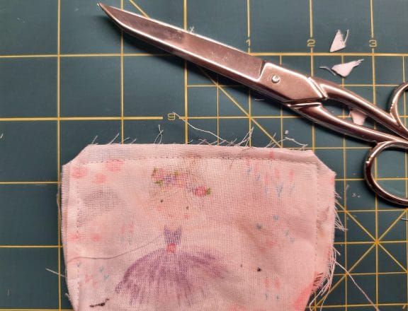 Sewing a corner bookmark: trim the corners of your fabric layers, being careful not to cut through the stitching.