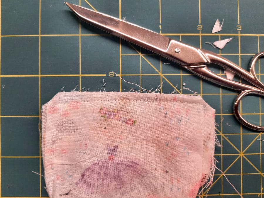 Sewing a corner bookmark: trim the corners of your fabric layers, being careful not to cut through the stitching.