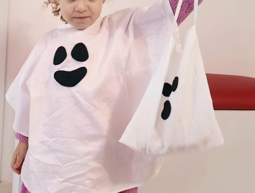 My daughter showing off her ghostly candy bag matching her ghost cape
