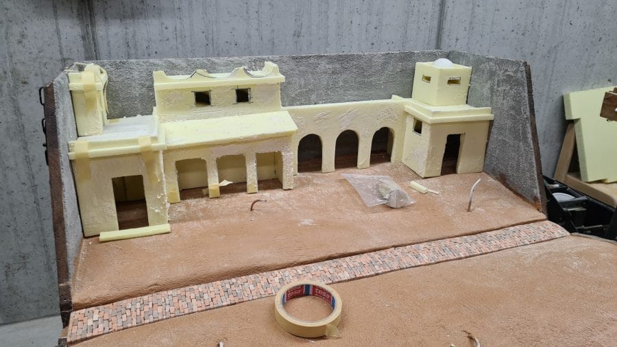 Making a Nativity diorama inside an antique steamer trunk: the foam houses in place