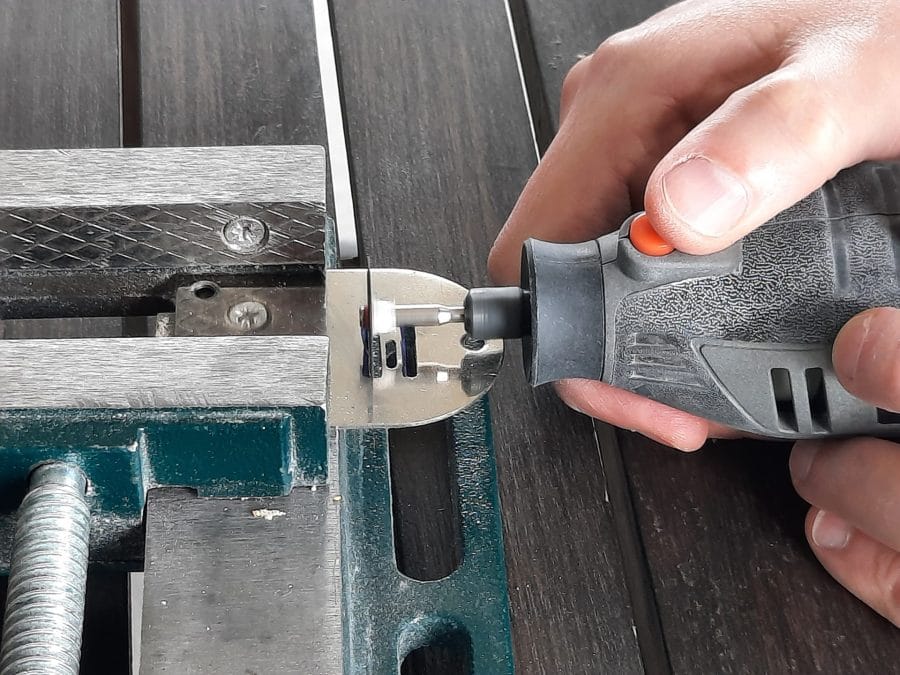 Trying to fix the feed dogs of my Orsha sewing machine by drilling the holes in the needle plate to make them fit