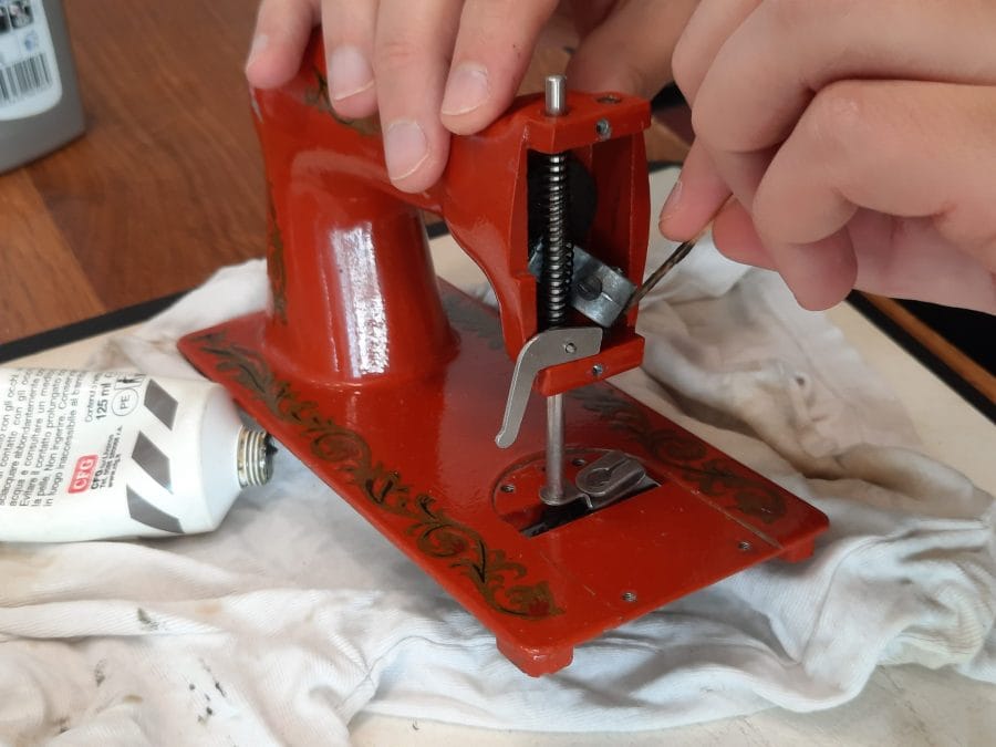 Putting grease on the inner mechanisms of the second Orsha sewing machine