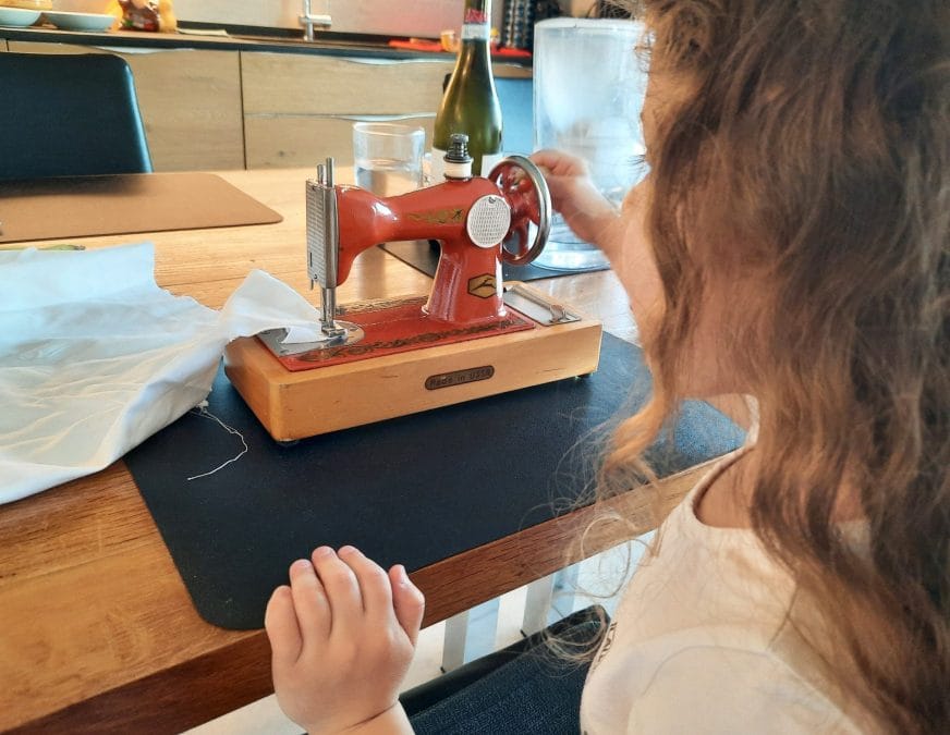 Our daughter testing her Orsha toy sewing machine