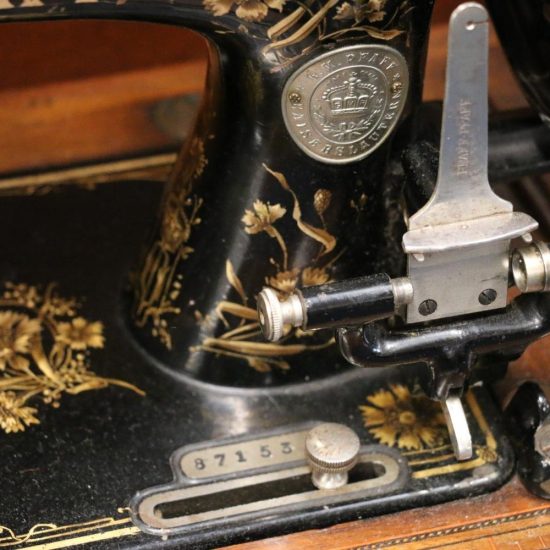 A Pfaff vintage sewing machine with the serial number on a metal plate inset into the bed, below the logo badge