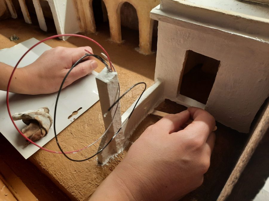 Making a Nativity diorama inside an antique steamer trunk: defining the space for the stable with a clay wall