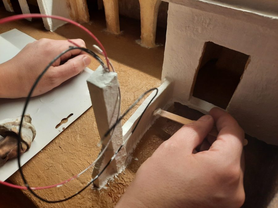 Making a Nativity diorama inside an antique steamer trunk: defining the space for the stable with a clay wall